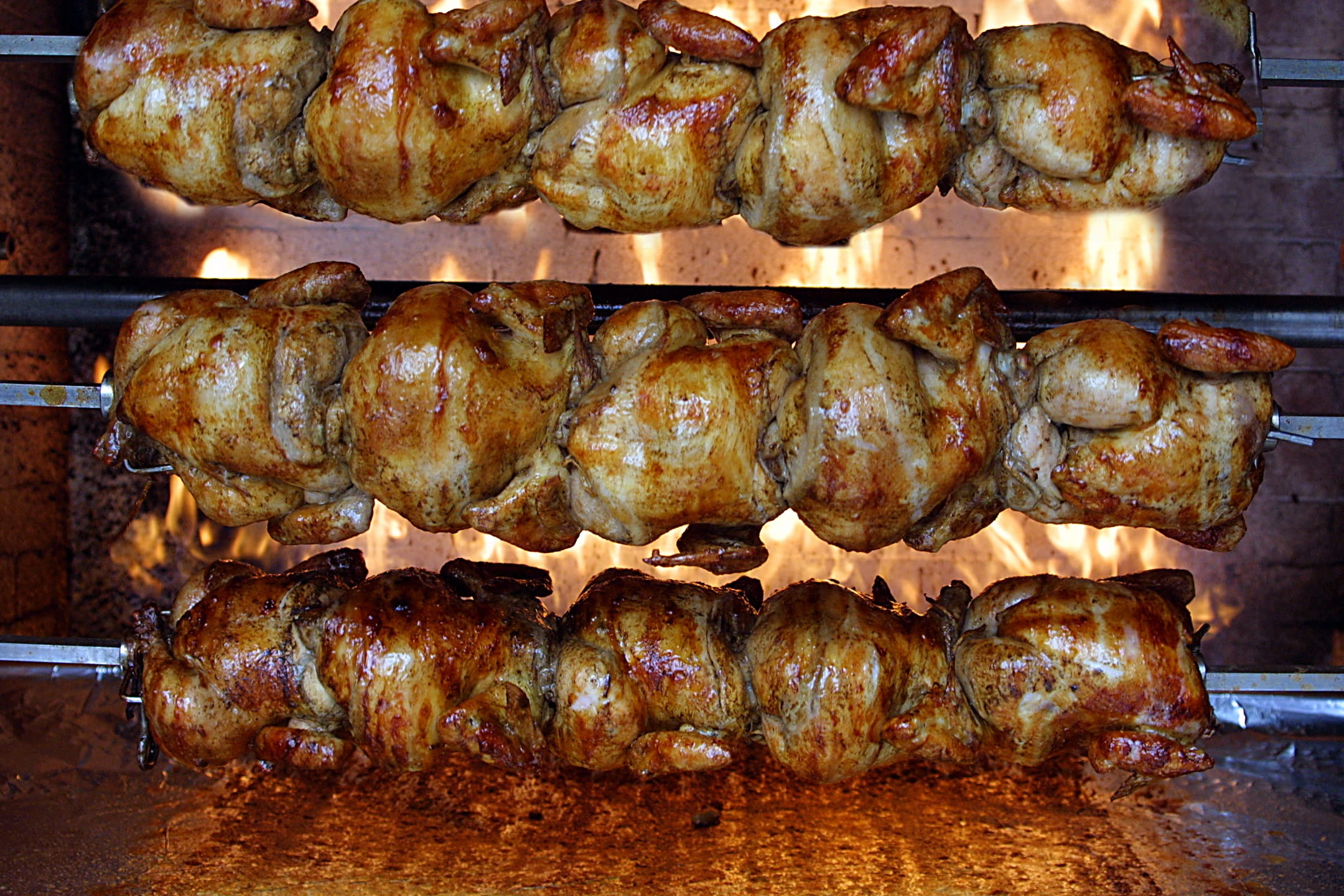 chicken cooking in a rotisserie oven